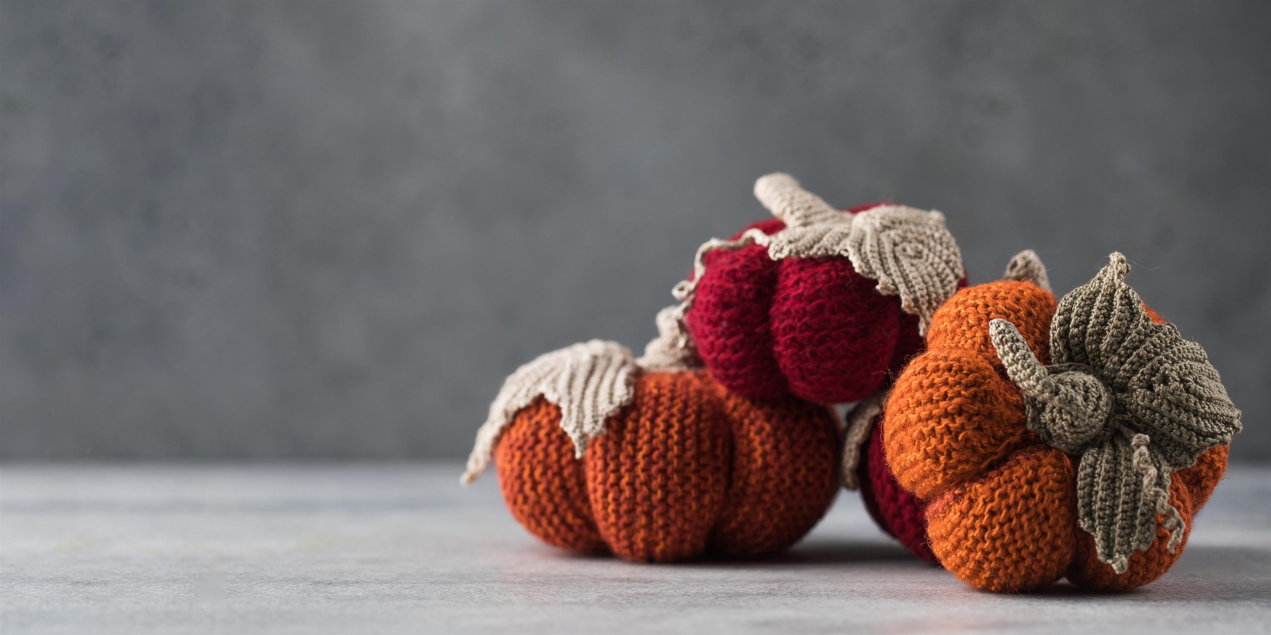 knitted-handmade-pumpkins-on-a-grey-background-a-2022-07-23-03-22-55-utc